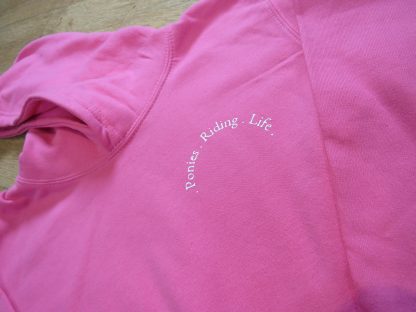 pink sweatshirt with riding logo